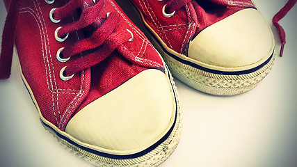 Image showing Old crimson sneakers, close-up