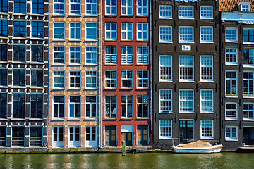 Image showing  houses and boat on Amsterdam canal  Damrak with reflection. Ams