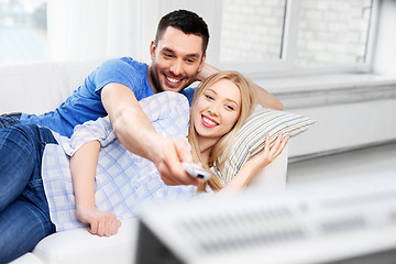 Image showing happy smiling couple watching tv at home