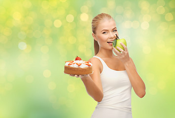 Image showing happy woman eating apple instead of cake