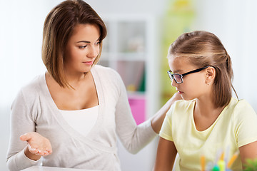 Image showing upset mother talking to daughter doing homework