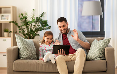 Image showing father and daughter having video call on tablet pc