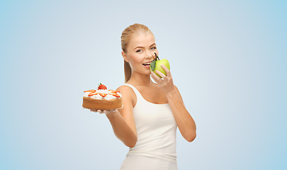 Image showing happy woman eating apple instead of cake