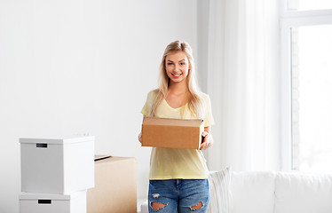 Image showing happy woman with boxes moving to new home