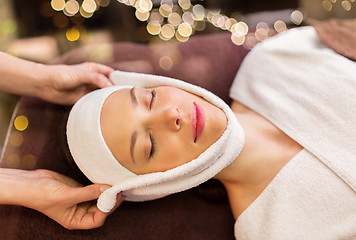 Image showing woman having face massage with towel at spa