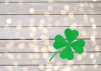 Image showing green paper four-leaf clover on wooden background