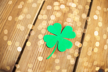 Image showing green paper four-leaf clover on wooden background