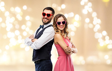 Image showing happy couple in heart-shaped sunglasses