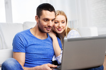 Image showing happy couple with laptop computer at home