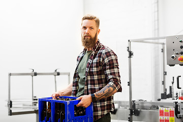 Image showing man with bottles in box at craft beer brewery