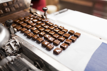 Image showing chocolate candies on conveyor at confectionery