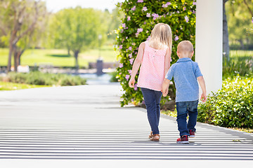 Image showing Young Sister and Brother Holding Hands And Walking At The Park