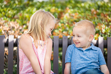 Image showing Young Sister and Brother Having Fun On The Bench At The Park