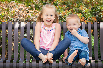 Image showing Young Sister and Brother Having Fun On The Bench At The Park