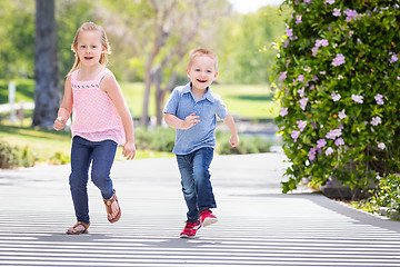 Image showing Young Sister and Brother Having Fun Running At The Park