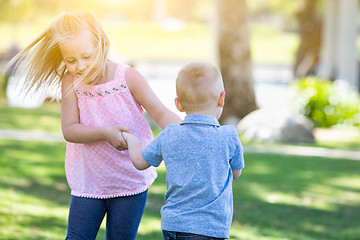 Image showing Young Brother and Sister Playing At The Park Togther