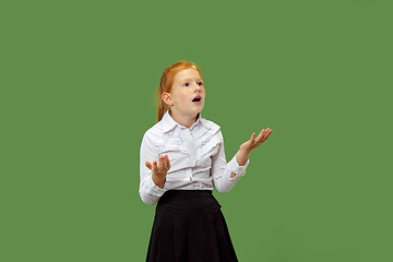 Image showing Beautiful teen girl looking suprised isolated on green