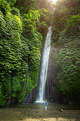 Image showing girl watching a waterfall in Bali Indonesia