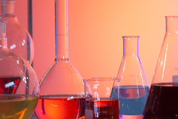 Image showing Backlit laboratory test flask containing colorful liquids.