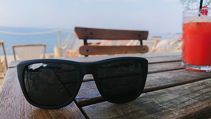 Image showing Sunglasses range cocktail on the wooden table