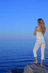 Image showing Calm young woman looking at the sea