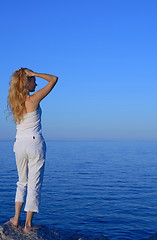 Image showing Beautiful young woman looking at the sea