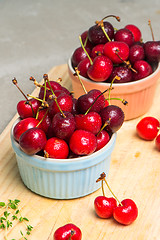 Image showing Red ripe cherries in ceramic bowls