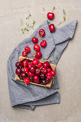 Image showing Red ripe cherries in small wooden box