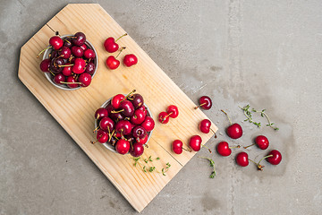 Image showing Red ripe cherries in ceramic bowls