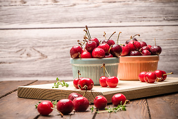 Image showing Red ripe cherries in ceramic bowls