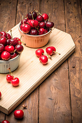 Image showing Red ripe cherries in ceramic bowls