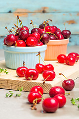 Image showing Red ripe cherries in ceramic bowls