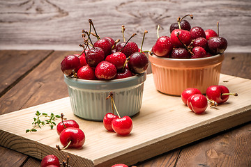 Image showing Red ripe cherries in ceramic bowls