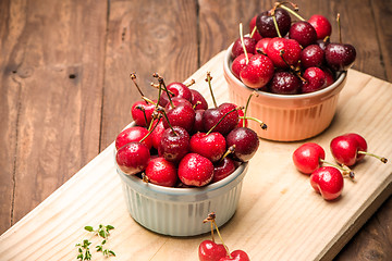 Image showing Red ripe cherries in ceramic bowls