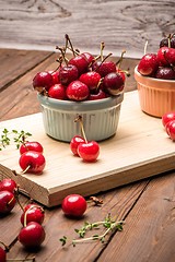 Image showing Red ripe cherries in ceramic bowls