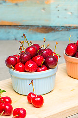 Image showing Red ripe cherries in ceramic bowls