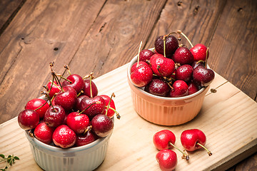 Image showing Red ripe cherries in ceramic bowls