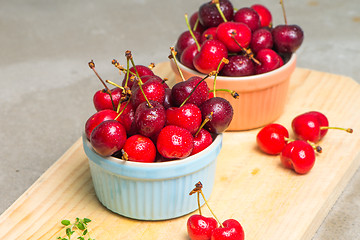 Image showing Red ripe cherries in ceramic bowls