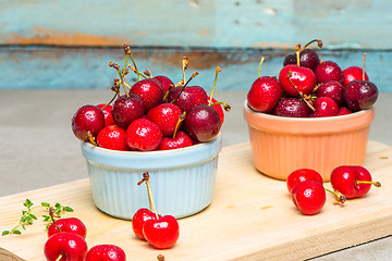 Image showing Red ripe cherries in ceramic bowls