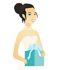 Image showing Woman in a white bridal dress holding a gift box.