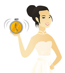 Image showing Young asian fiancee holding an alarm clock.