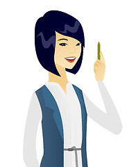 Image showing Young asian smiling business woman with a pen.