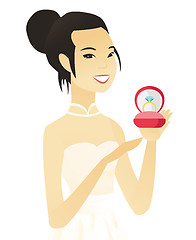 Image showing Young asian bride holding a wedding ring in a box.