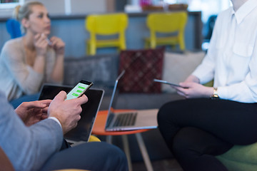 Image showing Young casual businessman using smartphone