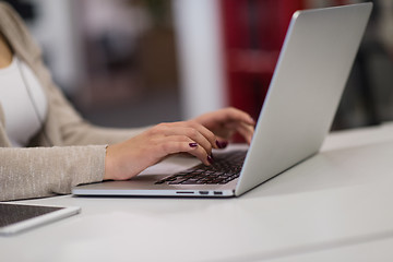 Image showing businesswoman using a laptop in startup office