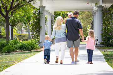 Image showing Young Caucasian Family Taking A Walk In The Park