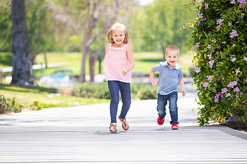 Image showing Young Sister and Brother Having Fun Running At The Park