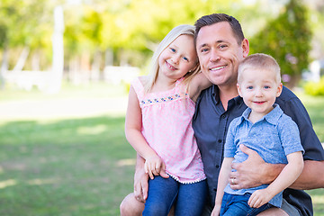 Image showing Young Caucasian Dad, Son and Daughter Having Fun In The Park