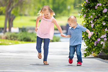 Image showing Young Sister and Brother Holding Hands And Running At The Park