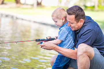 Image showing Young Caucasian Father and Son Having Fun Fishing At The Lake